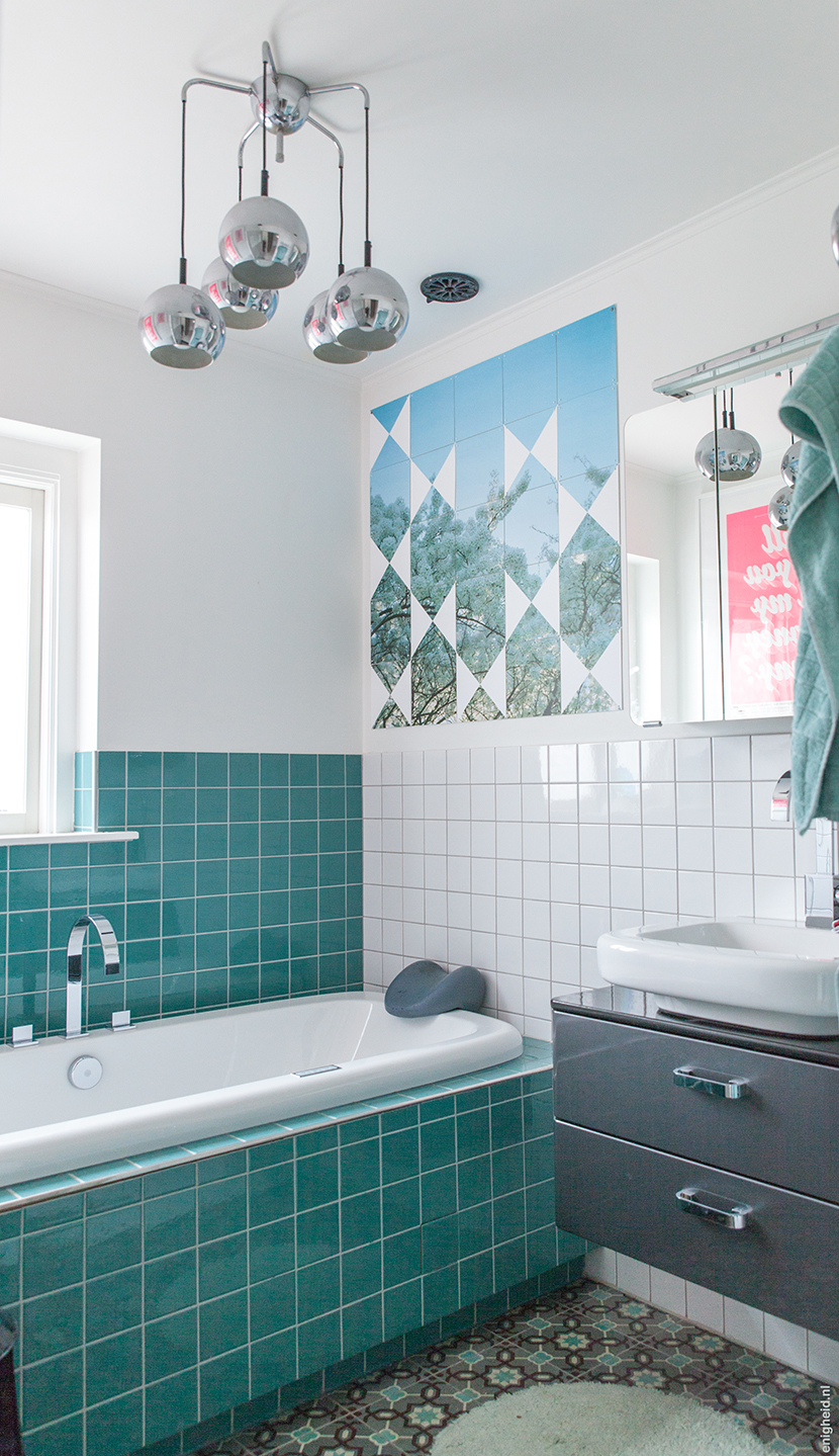 Bathrooms in the home of Iris Vank. Turquoise tiles on the wall, antique patterned tiles on the floor and the Dornbracht Mem series faucets. Studio Boot poster and self made Ixxi on the wall. | Enigheid